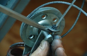 Use a screw driver to remove the cable and nut.