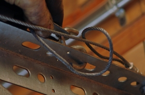 Adjust the extension springs by moving the S-hook.